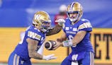 Winnipeg Blue Bombers running back Brady Oliveira (20) takes a handoff from quarterback Zach Collaros (8).