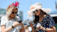 Kristen Heuing (left) and Jessica Tellez check their phones before the Kentucky Derby at Churchill Downs.