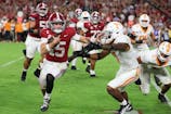 Alabama Crimson Tide quarterback Ty Simpson (15) is forced out of bounds by Tennessee Volunteers linebacker Arion Carter (7) in he fourth quarter at Saban Field at Bryant-Denny Stadium. David Leong-Imagn Images