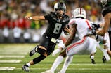 Oregon Ducks quarterback Dillon Gabriel (8) carries the ball for a touchdown during the second half against the Ohio State Buckeyes at Autzen Stadium. Mandatory Credit: Troy Wayrynen-Imagn Images