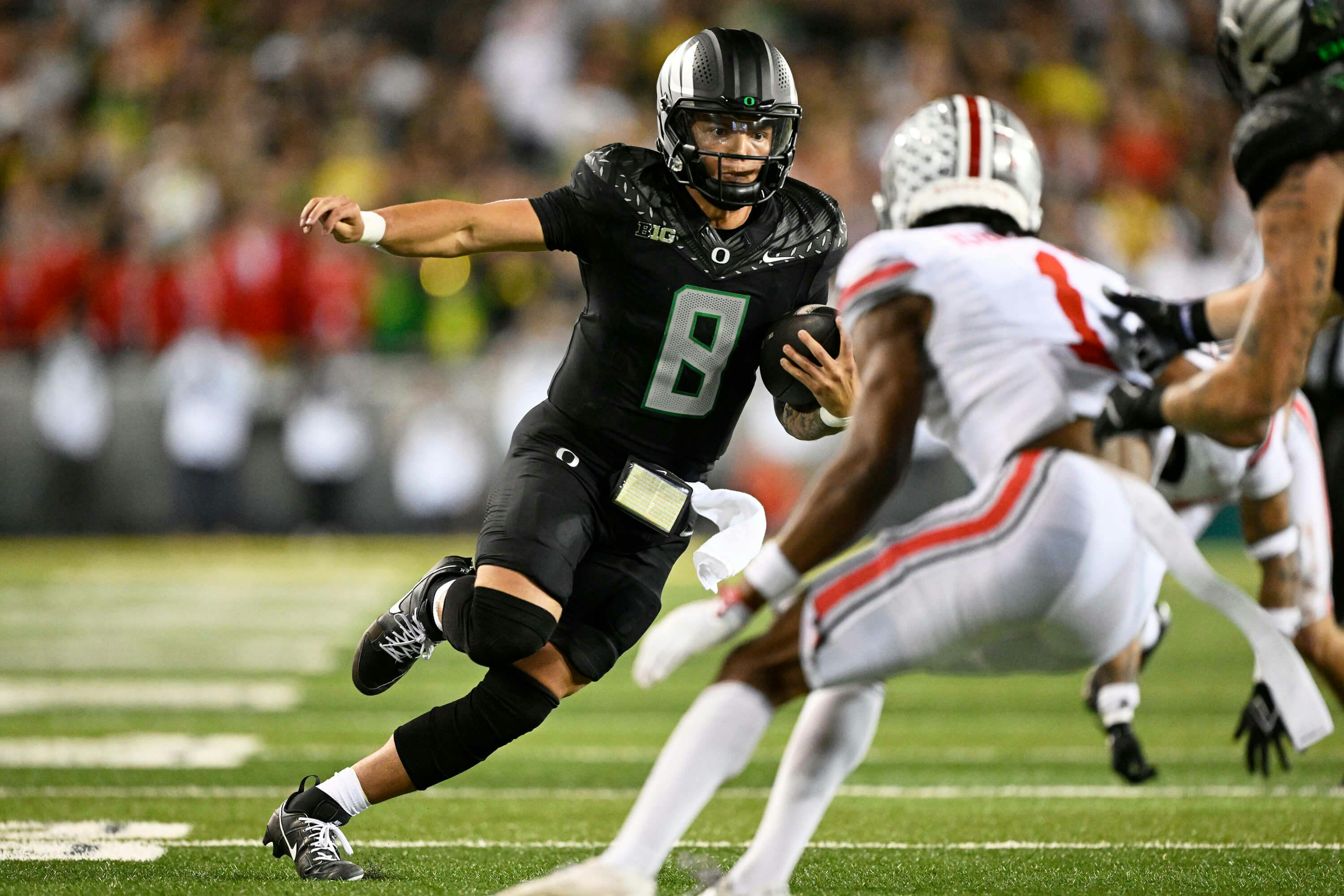 Oregon Ducks quarterback Dillon Gabriel (8) carries the ball for a touchdown during the second half against the Ohio State Buckeyes at Autzen Stadium. Mandatory Credit: Troy Wayrynen-Imagn Images