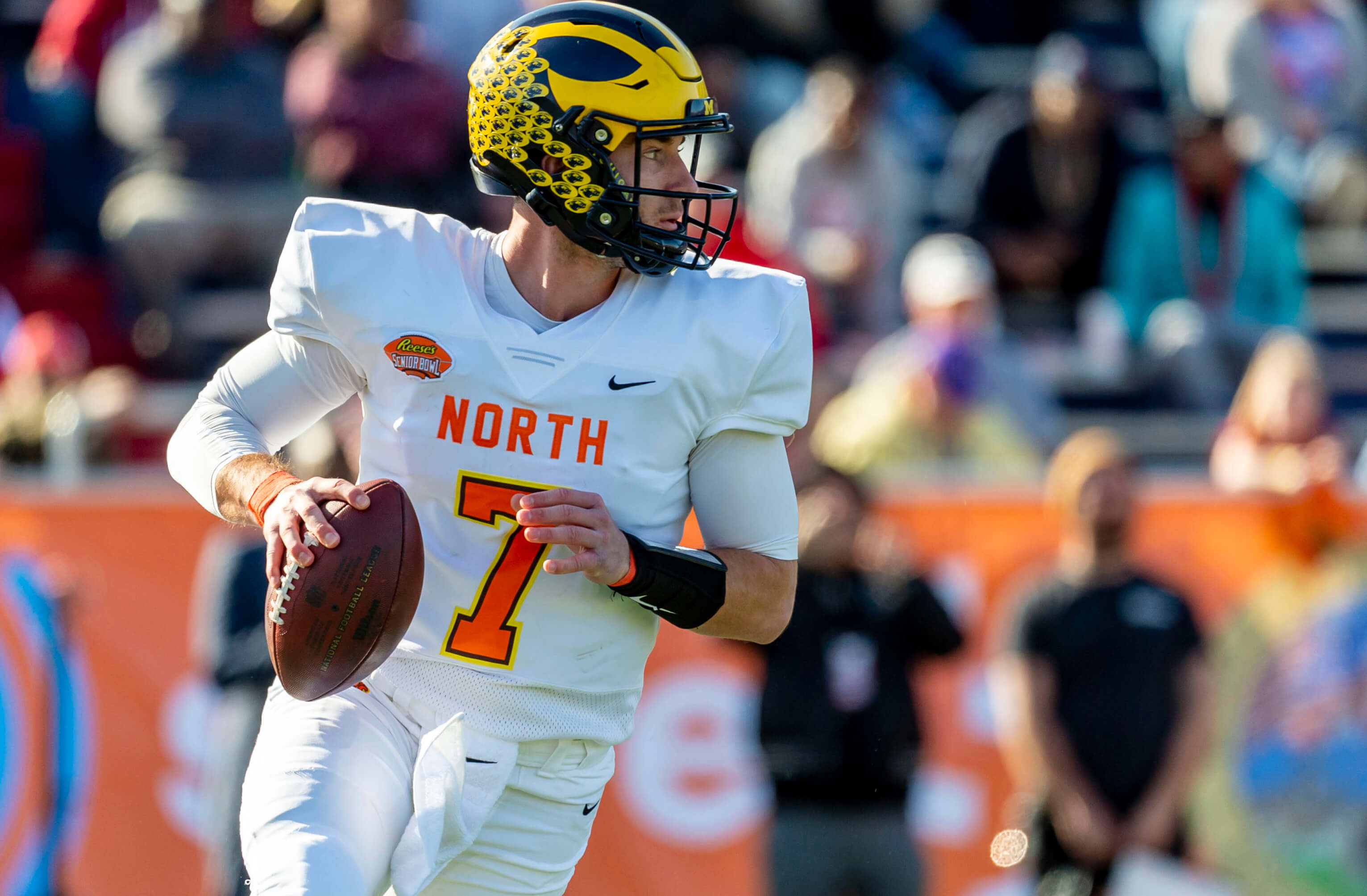 North quarterback Shea Patterson of Michigan (7) rolls out during the 2020 Senior Bowl college football game at Ladd-Peebles Stadium.