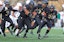 Army Black Knights outside linebacker Andre Carter (34) picks up a ball after a fumble that was later called back for a penalty against the Massachusetts Minutemen during the second half at Michie Stadium.