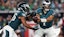 Philadelphia Eagles quarterback Jalen Hurts (1) hands off the ball to running back Saquon Barkley (26).