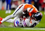 Denver Broncos cornerback Ja'quan McMillian (29) intercepts a pass intended for Buffalo Bills wide receiver Brandin Cooks (18) during overtime of an AFC Divisional Round playoff game at Empower Field at Mile High. Ron Chenoy-Imagn Images