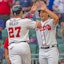 Atlanta Braves teammates Austin Riley and Matt Olson celebrate at home plate in MLB action.