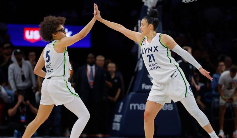 Olive Miles and Kayla McBride celebrate. 