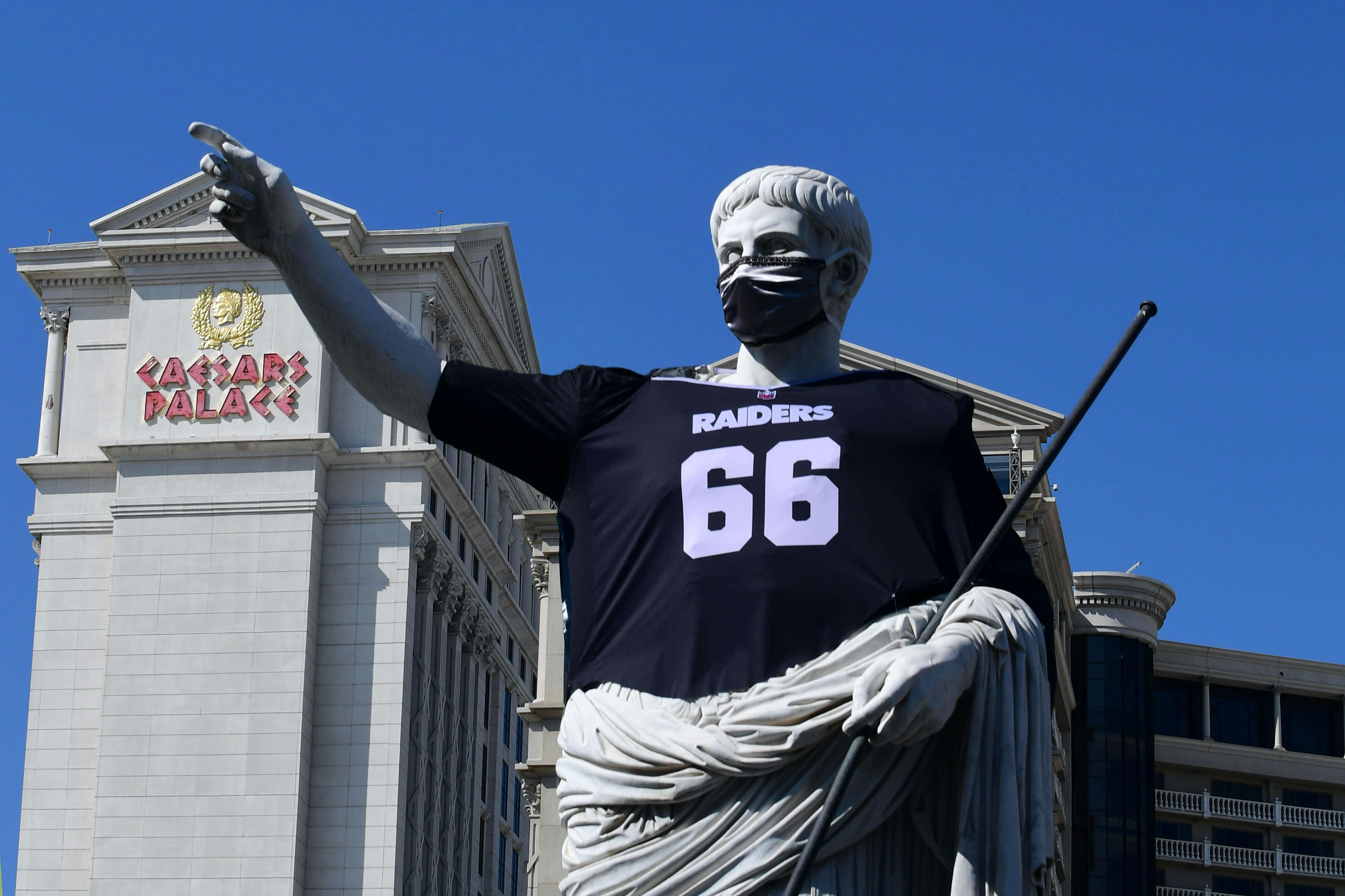 A statue at Caesars Palace Las Vegas wears a Las Vegas Raiders jersey.