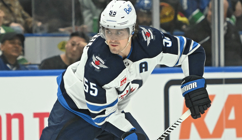 Mark Scheifele (55) skates with the puck against against the Vancouver Canucks.