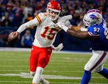 Kansas City quarterback Patrick Mahomes gets forced into throwing an incompletion by Bills Jordan Phillips who grabbed him by the shoulder pads during second half action against the Kansas City Chiefs in Orchard Park, Nov.17, 2024.