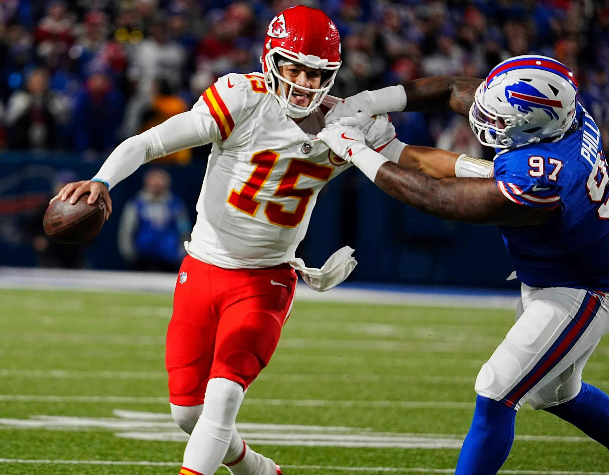 Kansas City quarterback Patrick Mahomes gets forced into throwing an incompletion by Bills Jordan Phillips who grabbed him by the shoulder pads during second half action against the Kansas City Chiefs in Orchard Park, Nov.17, 2024.