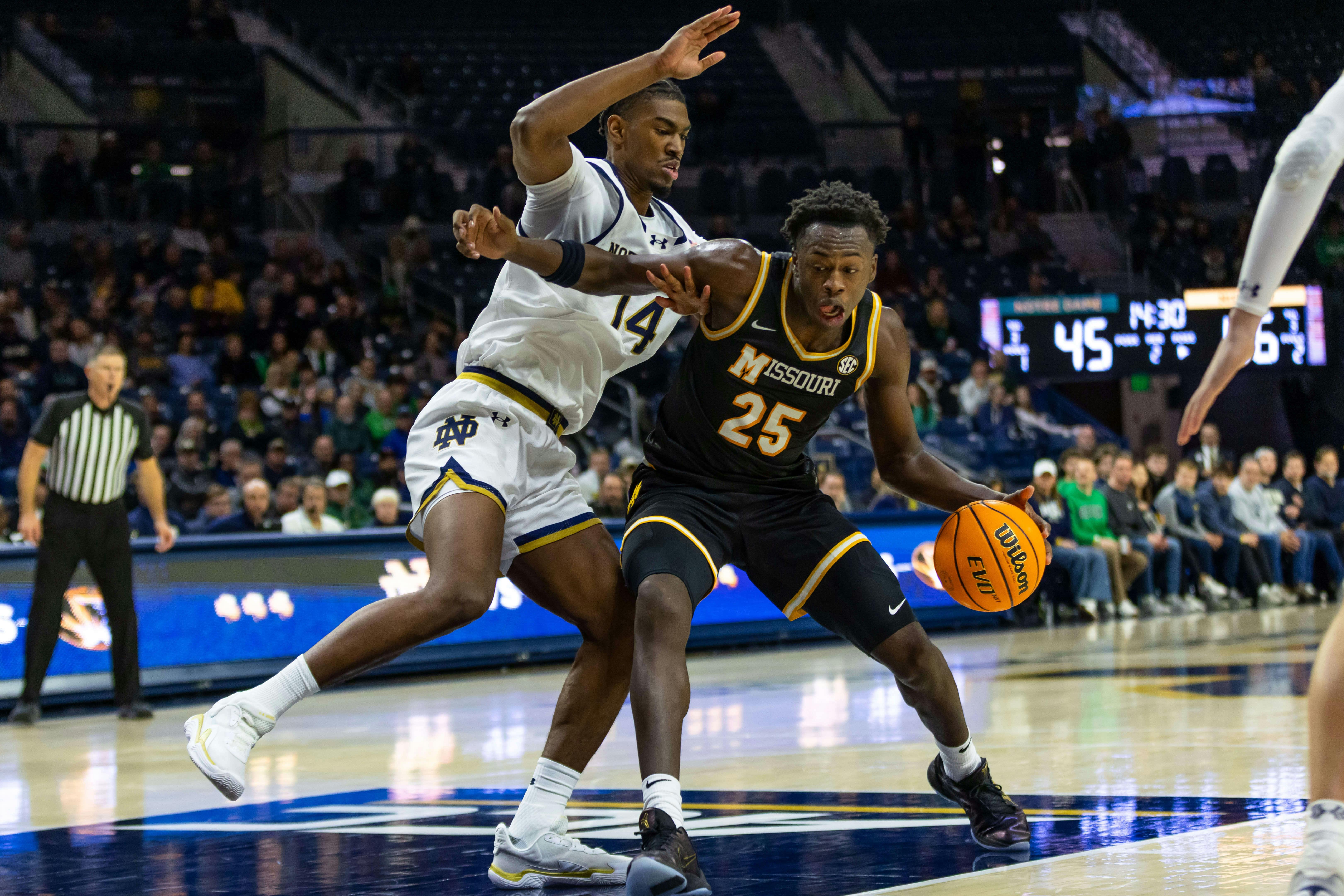 Missouri Tigers forward Mark Mitchell (25) works against Notre Dame Fighting Irish forward Kebba Njie (14) during the second half at Purcell Pavilion at the Joyce Center. Michael Caterina-Imagn Images