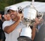 Brooks Koepka is handed the Wanamaker Trophy on the 18th green following his victory at the PGA Championship at Oak Hill Country Club Sunday, May 21, 2023.