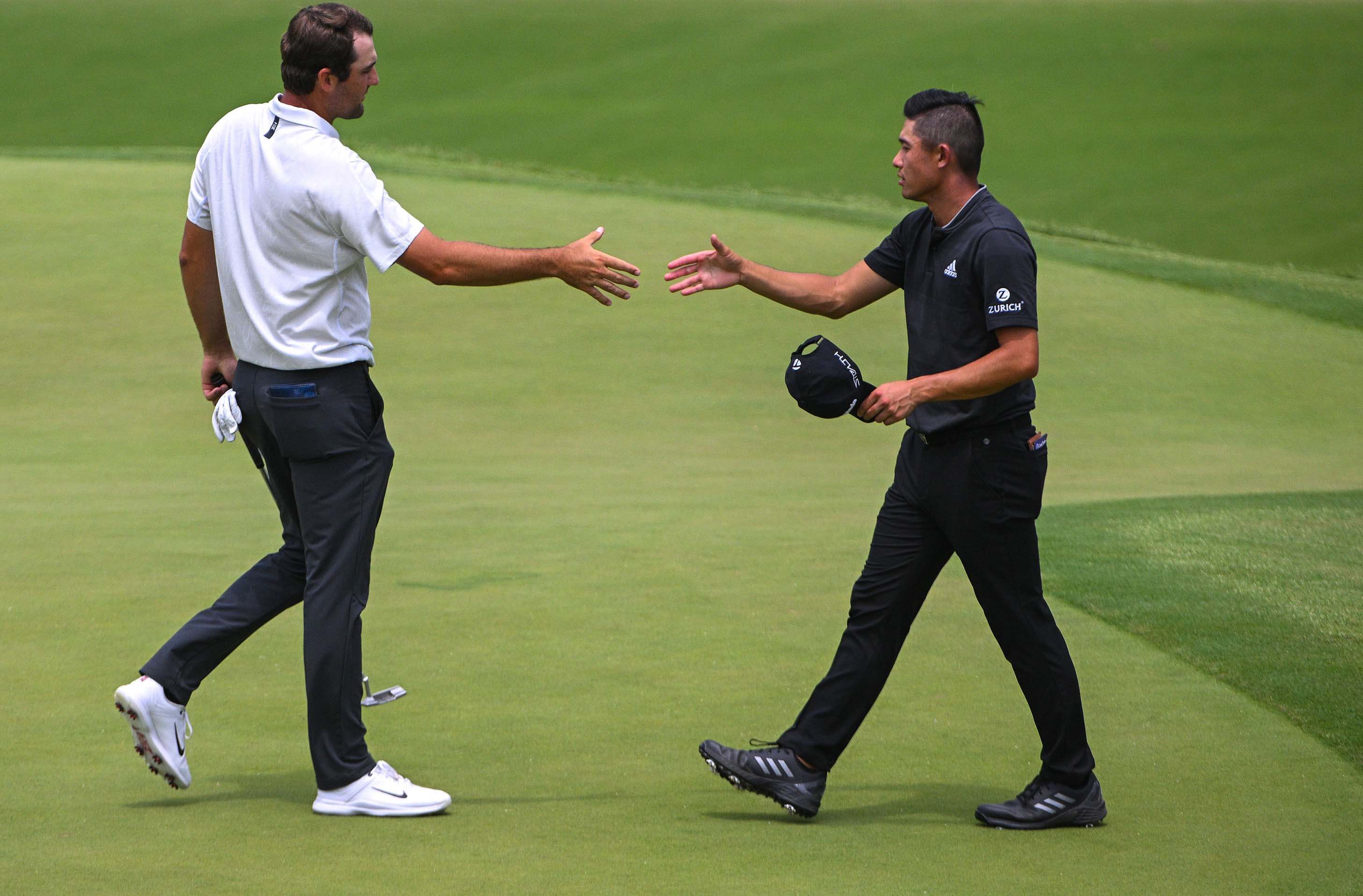 Scottie Scheffler (left) shakes hands with Collin Morikawa after they both finished the second round of the PGA Championship golf tournament at Southern Hills Country Club.