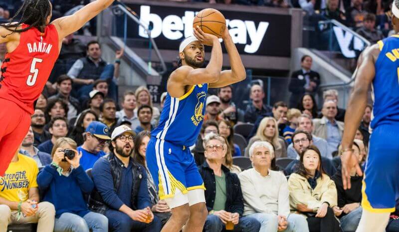 Golden State Warriors guard Moses Moody (4) takes a three-point shot.