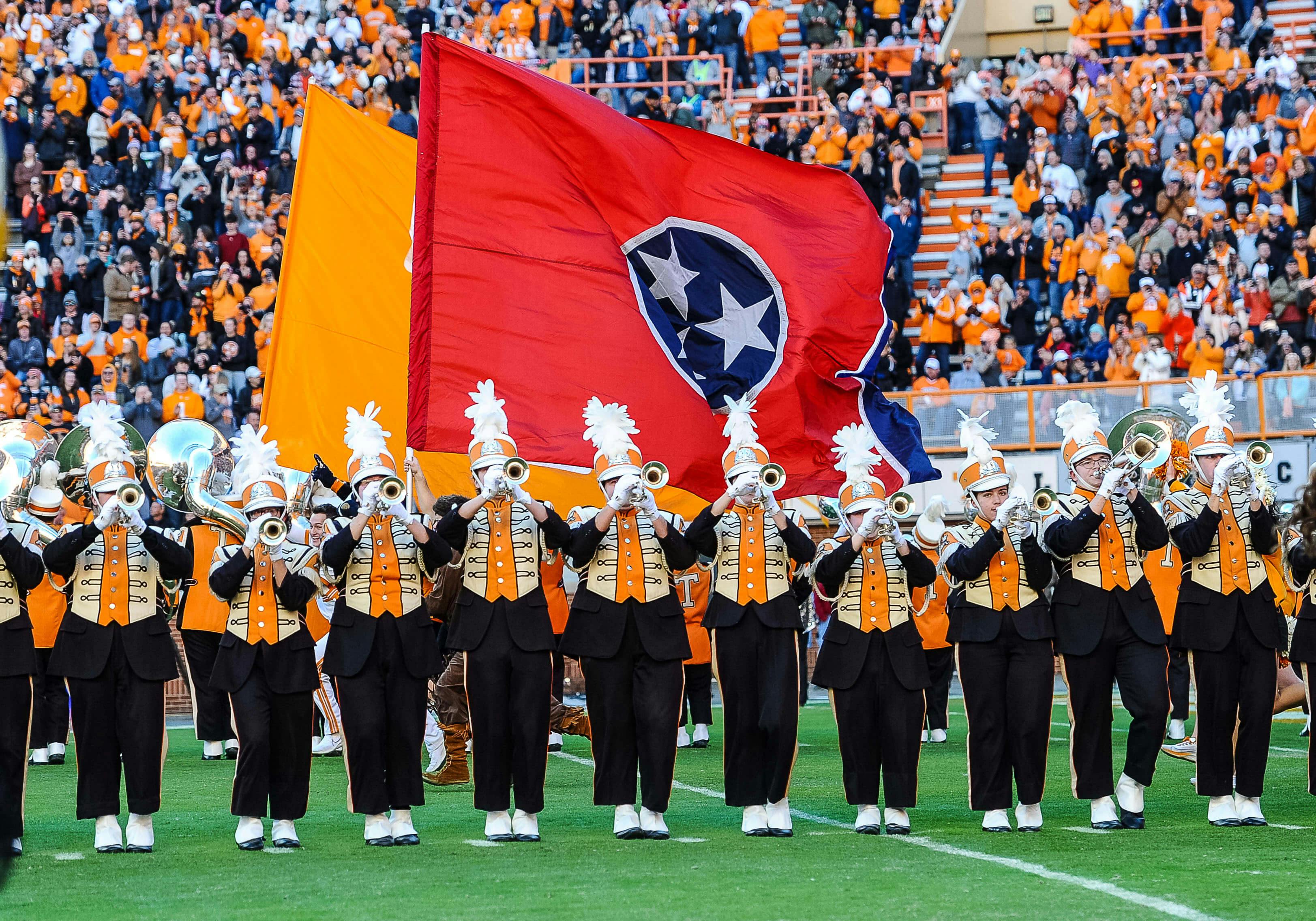 Tennessee Volunteers take the field behind the Tennessee state flag as the band plays before a game against the Vanderbilt Commodores at Neyland Stadium. Mandatory Credit: Bryan Lynn-Imagn Images