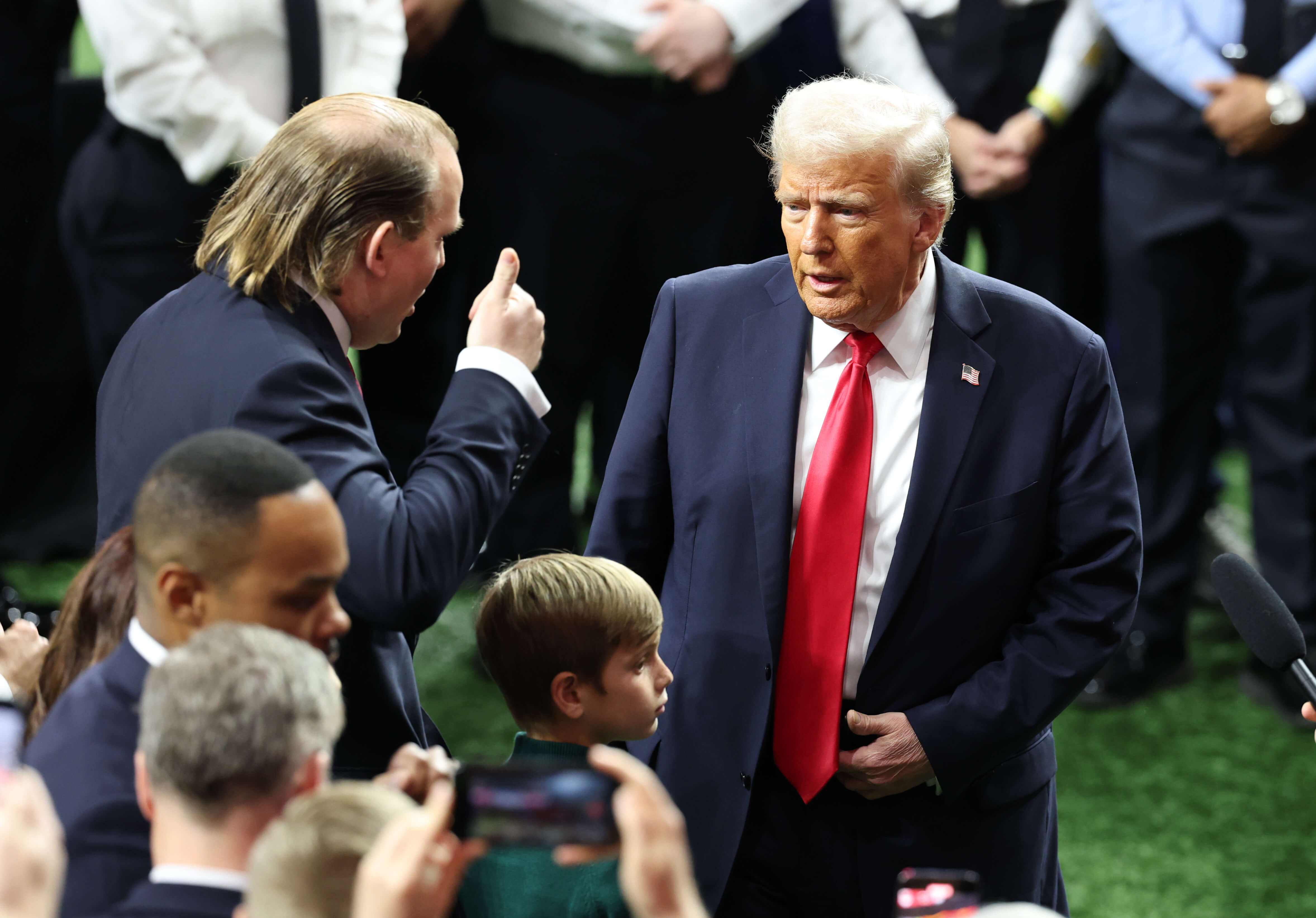 President Donald Trump participates in a meet and greet with the honorary coin toss participants including family members of the victims from the terrorist attack, members of the New Orleans Police Department, and emergency personnel before Super Bowl LIX 