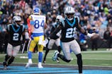 Carolina Panthers safety Nick Scott (21) celebrates after Carolina Panthers cornerback Mike Jackson (2) intercepts a pass to score a touchdown during the first quarter against the Los Angeles Rams at Bank of America Stadium. Scott Kinser-Imagn Images