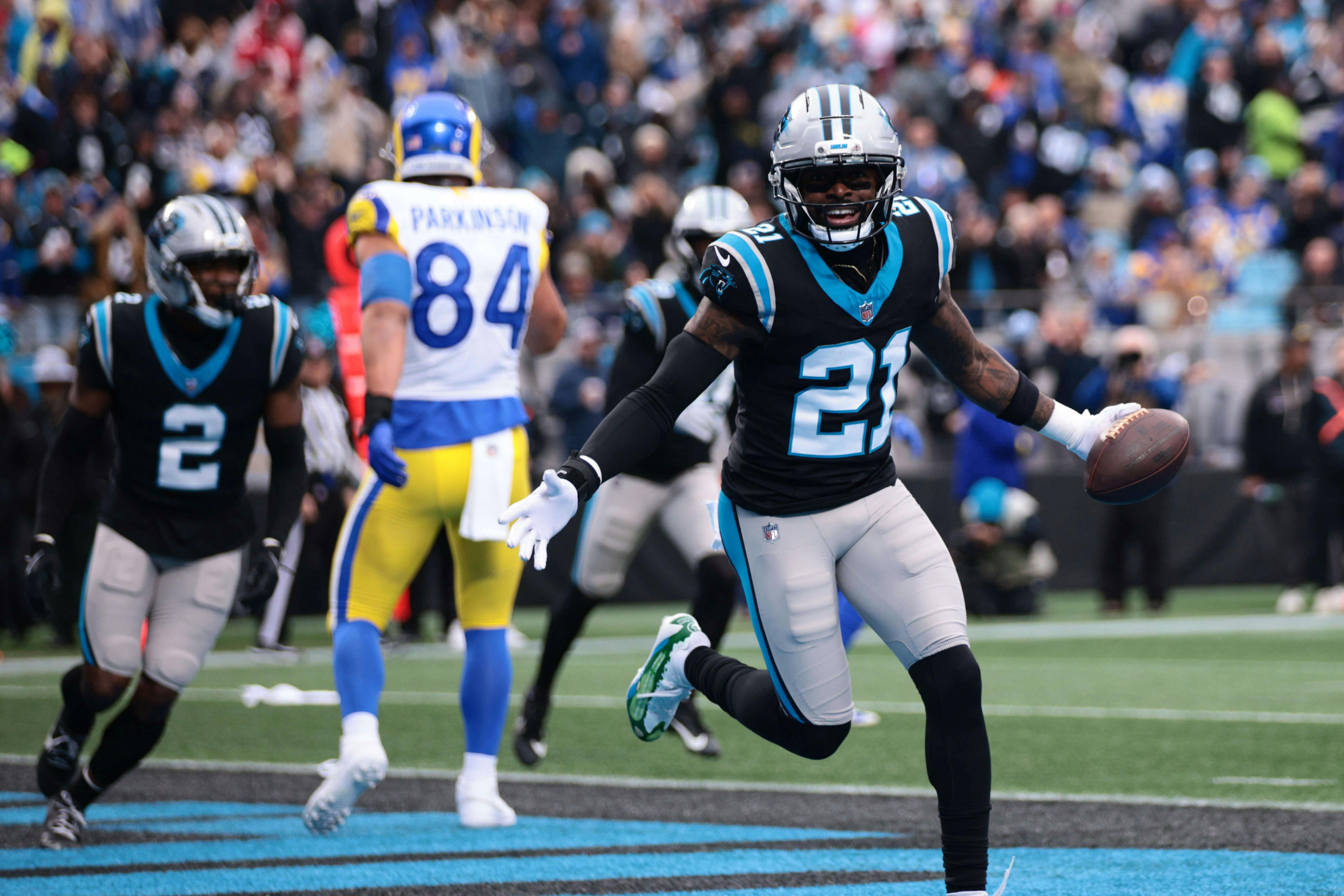 Carolina Panthers safety Nick Scott (21) celebrates after Carolina Panthers cornerback Mike Jackson (2) intercepts a pass to score a touchdown during the first quarter against the Los Angeles Rams at Bank of America Stadium. Scott Kinser-Imagn Images