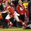 Kansas City Chiefs quarterback Patrick Mahomes (15) scrambles up the field against Buffalo Bills defensive end Boogie Basham (96) during the third quarter of the AFC Divisional playoff football game at GEHA Field at Arrowhead Stadium.