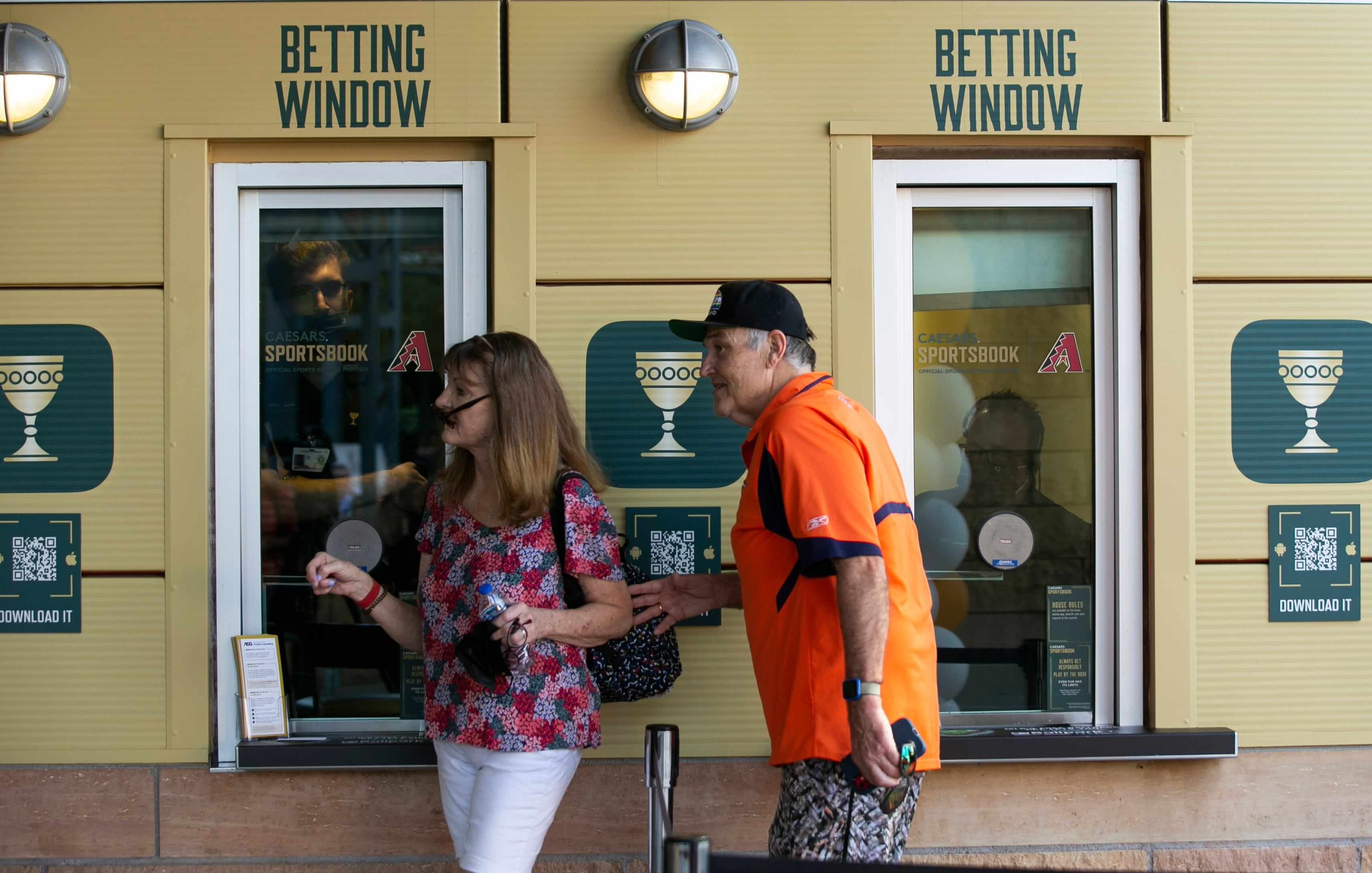 Marlys Kybartas and her husband, Ed Kybartas, walk by the Caesars Sportsbook betting window at Chase Field in Phoenix on the first day of sports betting on Sept. 9, 2021. Caesars Sportsbook At Chase Field
