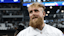 Boxer and influencer Jake Paul walks on the field before a game between the New Orleans Saints and Dallas Cowboys at AT&T Stadium.