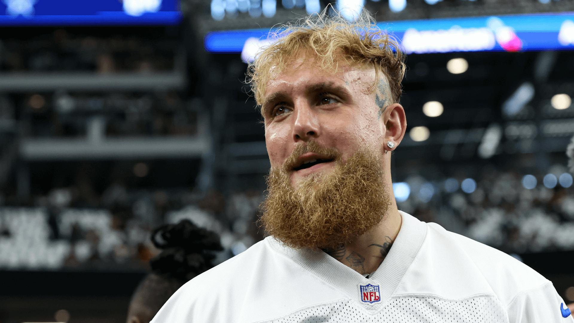 Boxer and influencer Jake Paul walks on the field before a game between the New Orleans Saints and Dallas Cowboys at AT&T Stadium.