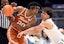 Texas guard Tre Johnson (20) keeps the ball away from Vanderbilt guard Chris Manon (30) during a NCAA college basketball first round game at the men’s Southeastern Conference Tournament Wednesday, March 12, 2025, in Nashville, Tenn.