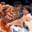Texas guard Tre Johnson (20) keeps the ball away from Vanderbilt guard Chris Manon (30) during a NCAA college basketball first round game at the men’s Southeastern Conference Tournament Wednesday, March 12, 2025, in Nashville, Tenn.