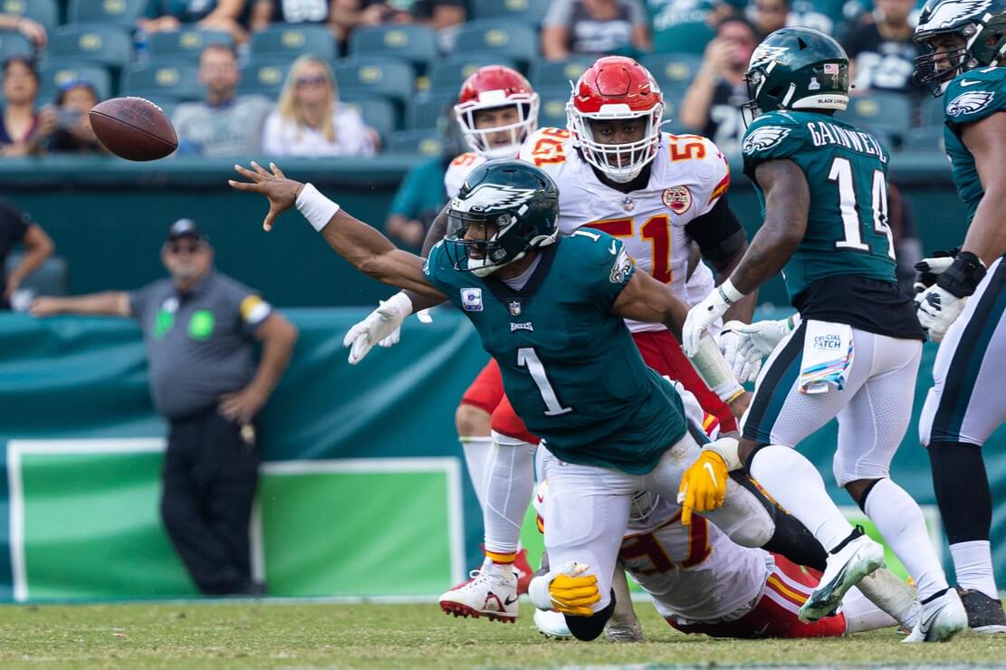 Philadelphia Eagles quarterback Jalen Hurts (1) throws for a completion while falling to the ground during the fourth quarter against the Kansas City Chiefs at Lincoln Financial Field.