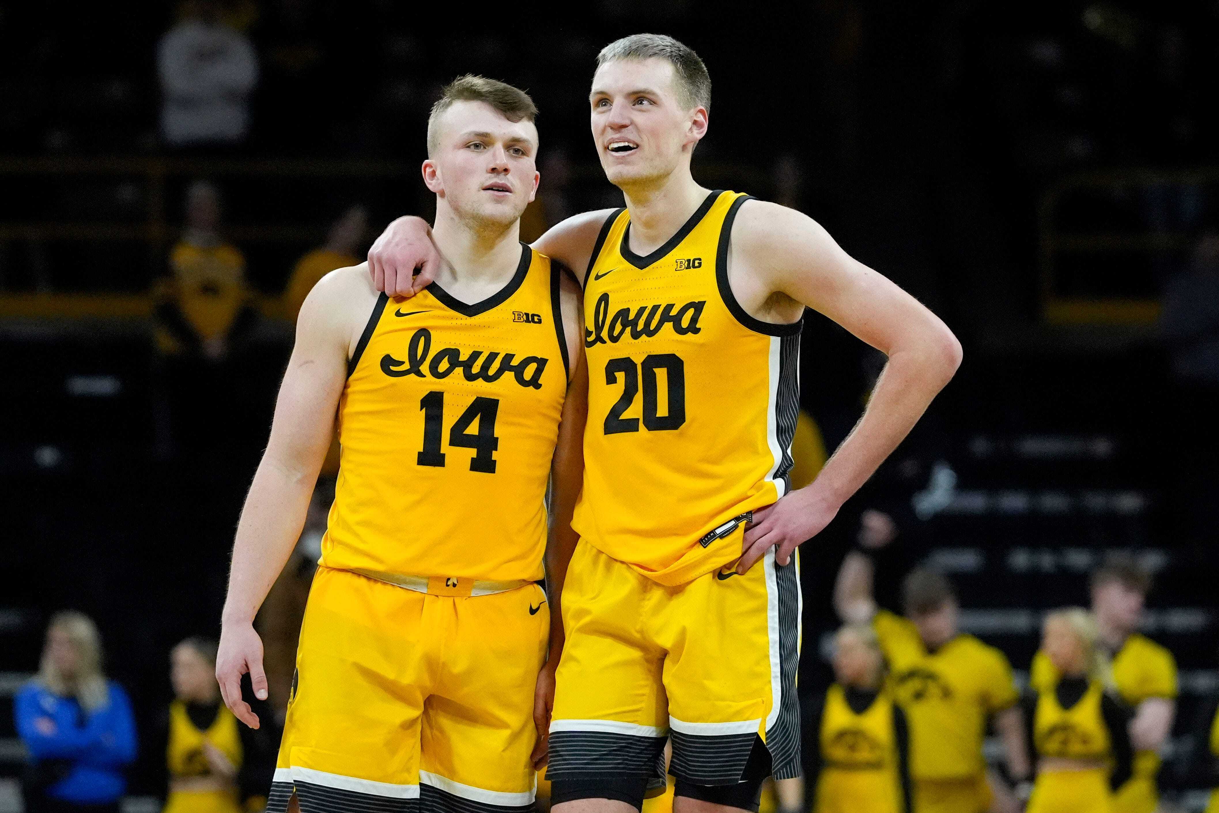 Iowa Hawkeyes guard Carter Kingsbury (14) and Iowa Hawkeyes forward Payton Sandfort (20) stand together as free throws are shot against the Washington Huskies Saturday, Feb. 22, 2025 at Carver-Hawkeye Arenain Iowa City, Iowa