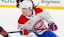 Montreal Canadiens forward Cole Caufield (13) looks to bat a puck in midair.