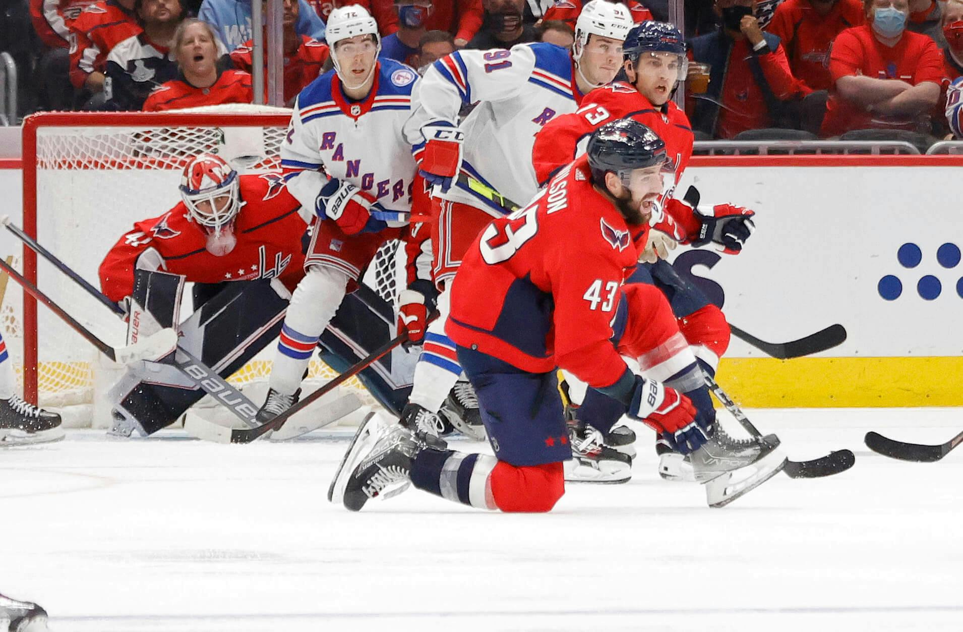 ew York Rangers defenseman Jacob Trouba (8) shoots the puck as Washington Capitals right wing Tom Wilson (43) defends during the first period at Capital One Arena.