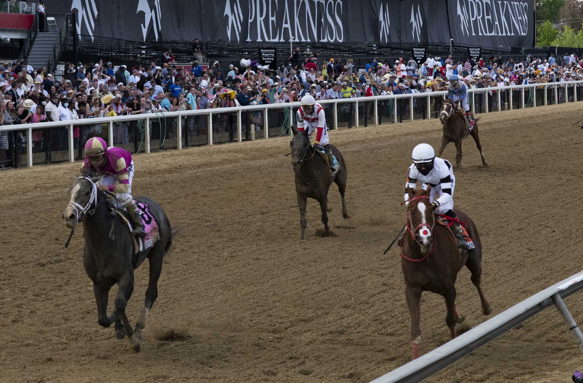 Horses approach the finish line during the 146th running of the Preakness Stakes at Pimlico Race Course.