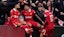  Liverpool's Mohamed Salah (right) and team-mates celebrate victory and the Premier League title following the Premier League match at Anfield.