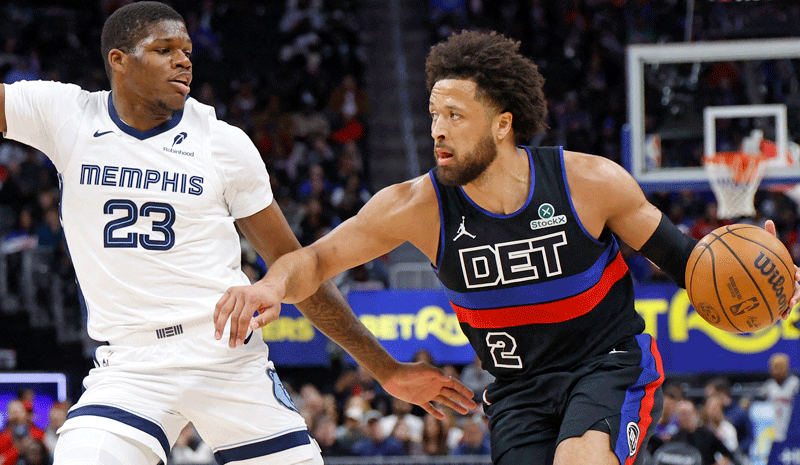  Cade Cunningham (2) dribbles defended by Memphis Grizzlies forward Cedric Coward (23) in the first half at Little Caesars Arena.