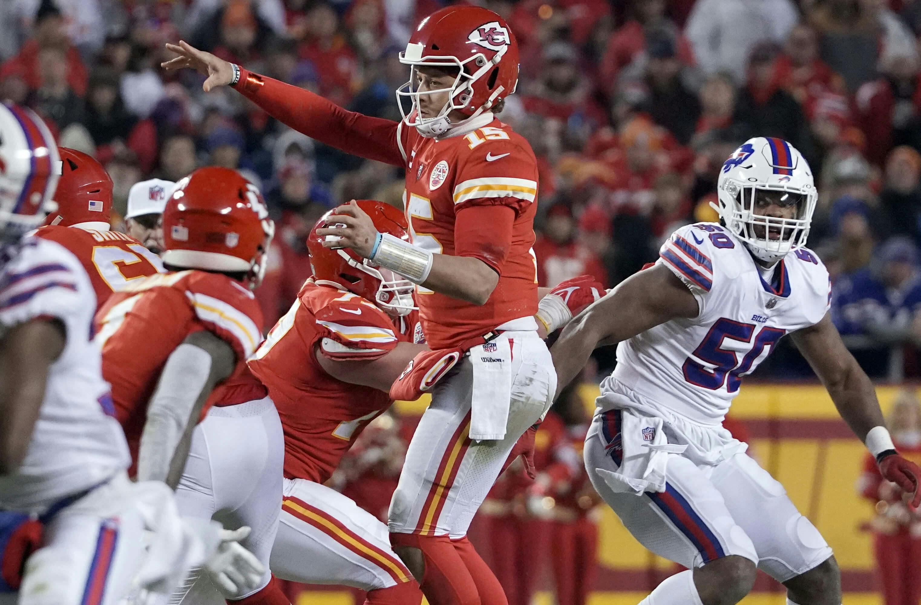 Kansas City Chiefs quarterback Patrick Mahomes (15) passing against the Buffalo Bills during overtime in the AFC Divisional playoff football game at GEHA Field at Arrowhead Stadium.