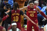 Cleveland Cavaliers guard Darius Garland (10) and guard Donovan Mitchell (45) celebrate a win over the Boston Celtics at Rocket Mortgage FieldHouse. Mandatory Credit: David Richard-Imagn Images