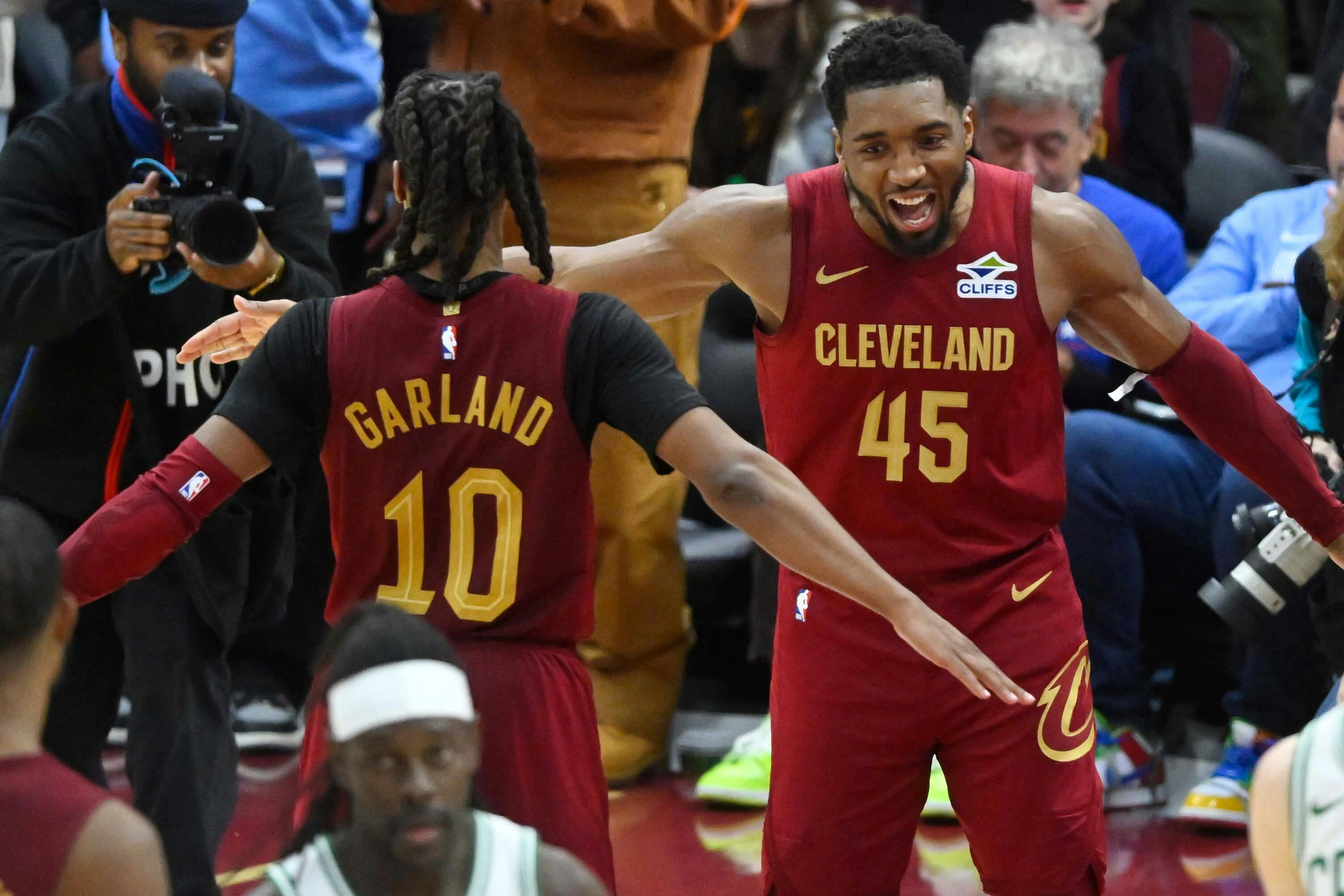 Cleveland Cavaliers guard Darius Garland (10) and guard Donovan Mitchell (45) celebrate a win over the Boston Celtics at Rocket Mortgage FieldHouse. Mandatory Credit: David Richard-Imagn Images