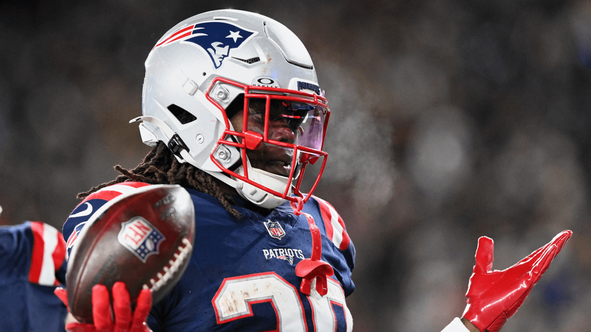 New England Patriots running back Rhamondre Stevenson (38) acknowledges the crowd after scoring a touchdown.