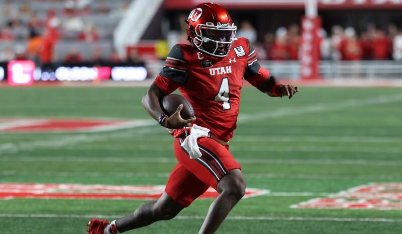 Utah Utes quarterback Devon Dampier (4) runs for yardage.