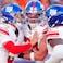 Jaxson Dart, Theo Johnson, and Andrew Thomas react after a play.