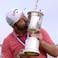 Jon Rahm celebrates with the trophy after winning he U.S. Open golf tournament at Torrey Pines Golf Course.