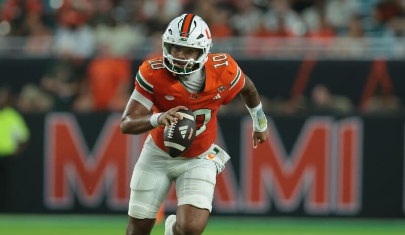 Miami Hurricanes quarterback Darian Mensah (10) runs with the ball.