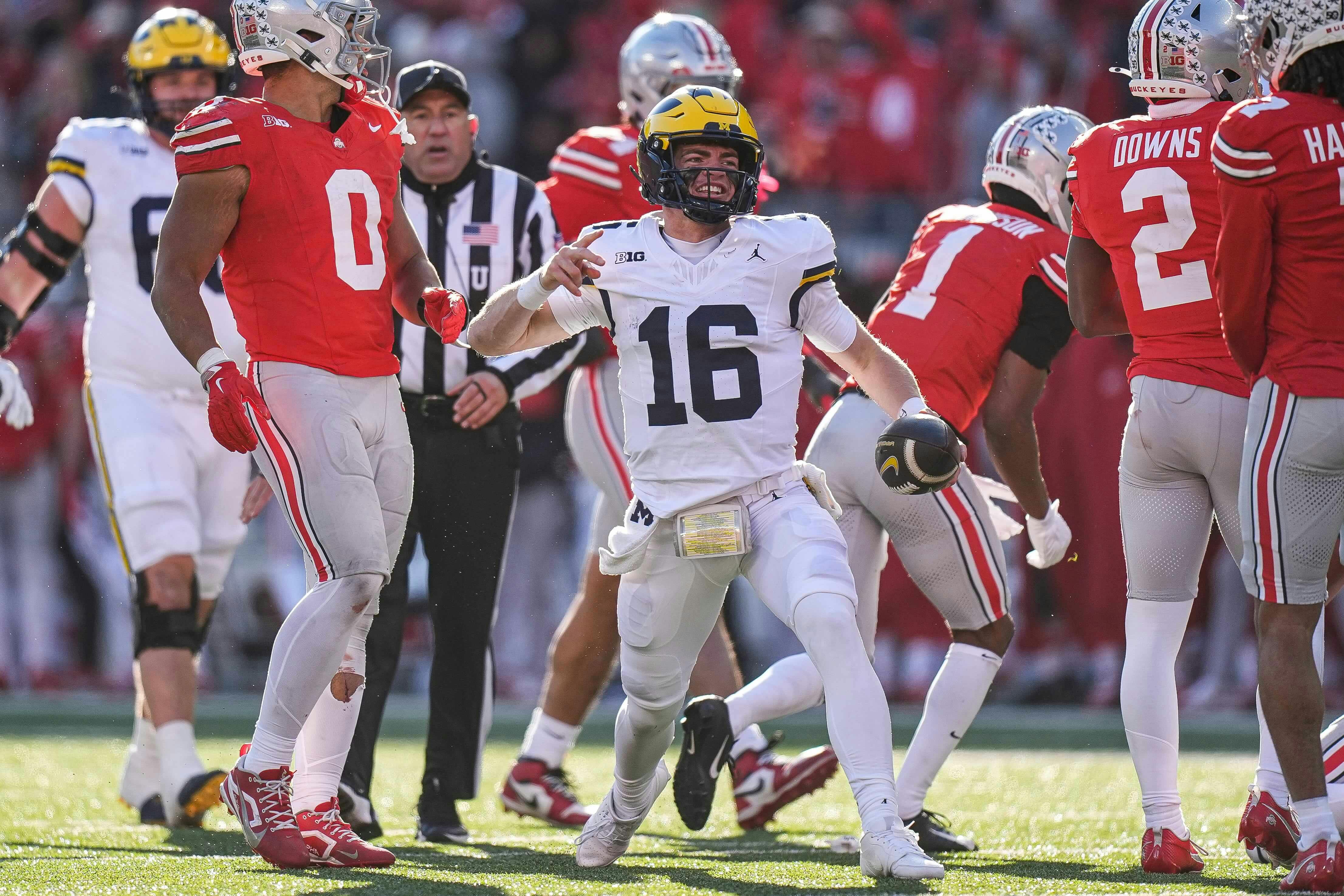 Michigan quarterback Davis Warren (16) celebrates a first down against Ohio State during the second half at Ohio Stadium in Columbus, Ohio on Saturday, Nov. 30, 2024.