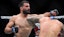 Benoit Saint Denis (blue gloves) fights Dustin Poirier (red gloves).