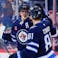 Winnipeg Jets forward Mark Scheifele (55) is congratulated by Winnipeg Jets forward Kyle Connor (81)
