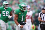 Philadelphia Eagles quarterback Jalen Hurts (1) reacts after his touchdown pass against the New York Giants during the fourth quarter at Lincoln Financial Field. Bill Streicher-Imagn Images