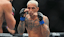 Ilia Topuria (red gloves) fights Charles Oliveira (blue gloves) during UFC 317 at T-Mobile Arena.