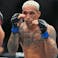 Ilia Topuria (red gloves) fights Charles Oliveira (blue gloves) during UFC 317 at T-Mobile Arena.
